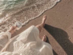 Hand reaching toward muted, washed-out colors