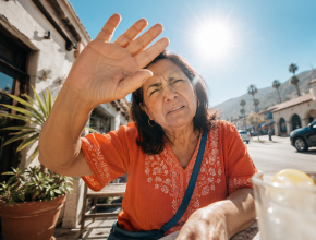 Person shielding their eyes from bright sunlight